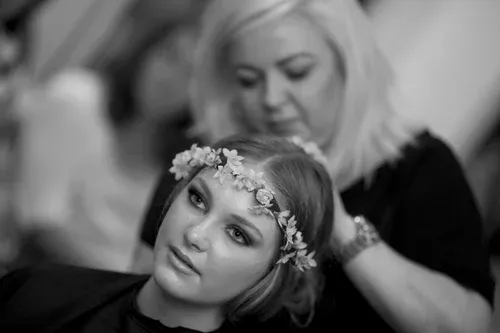 Lisa Fowler applying bridal hair flowers for a bride